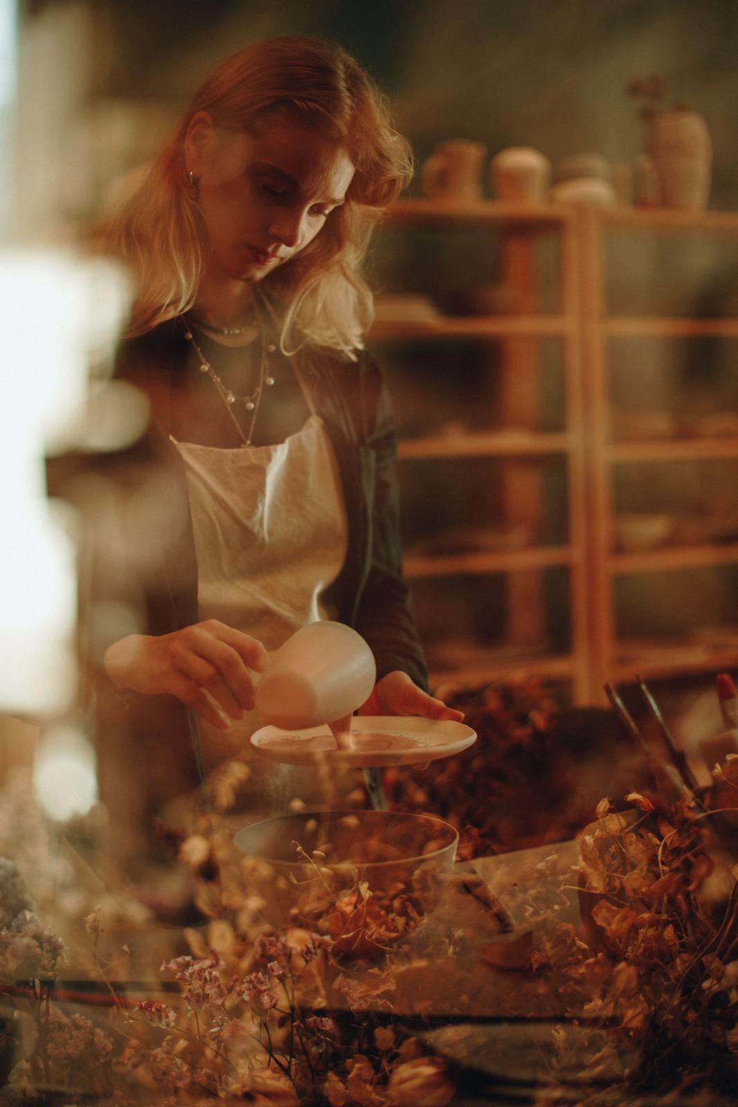 A guest shaping a clay bowl